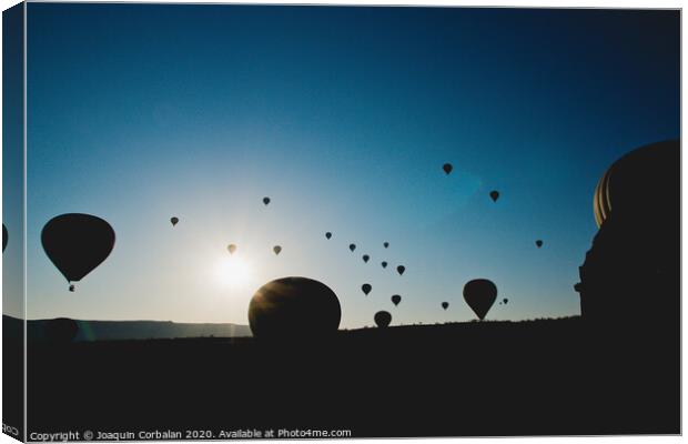 Colorful balloons flying over mountains and with blue sky Canvas Print by Joaquin Corbalan