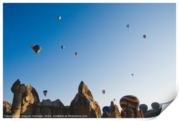 Colorful balloons flying over mountains and with blue sky Print by Joaquin Corbalan