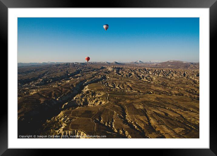 Colorful balloons flying over mountains and with blue sky in cappadocia Framed Mounted Print by Joaquin Corbalan