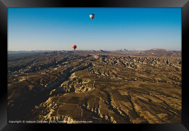 Colorful balloons flying over mountains and with blue sky in cappadocia Framed Print by Joaquin Corbalan