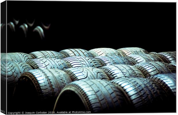 Old tires and racing wheels stacked in the sun Canvas Print by Joaquin Corbalan
