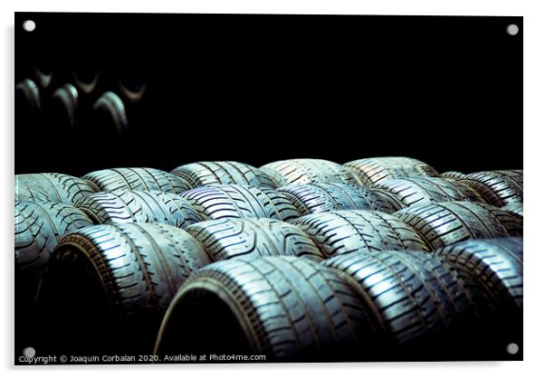 Old tires and racing wheels stacked in the sun Acrylic by Joaquin Corbalan