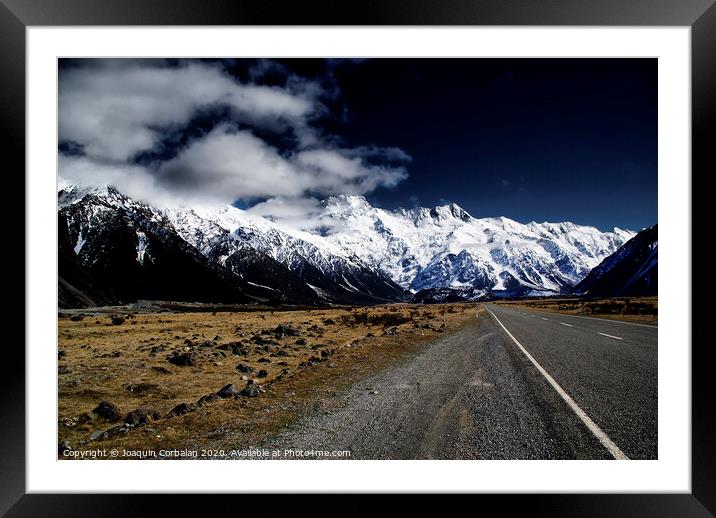 Snowy mountains among clouds from road Framed Mounted Print by Joaquin Corbalan