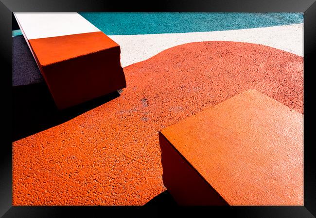 Asphalt floor painted in orange, with concrete blocks of harsh shadows of sunlight, abstract background. Framed Print by Joaquin Corbalan