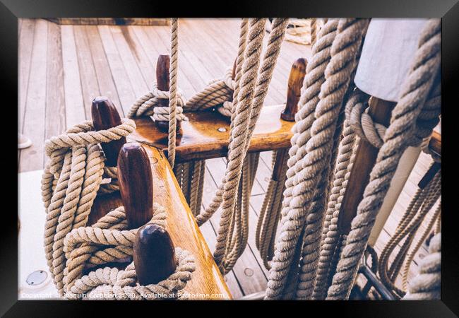 Boat mooring ropes wound on a sailboat. Framed Print by Joaquin Corbalan