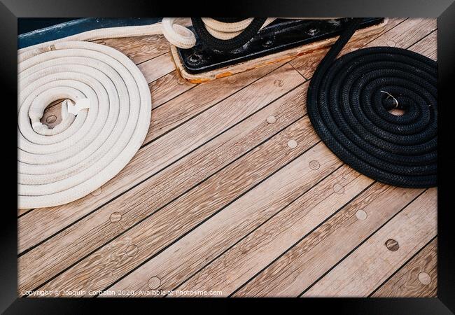 Boat mooring ropes wound on a sailboat. Framed Print by Joaquin Corbalan