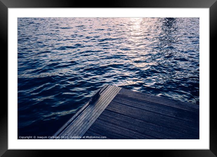 Sunset on a seawater jetty, with retro blue vintage tones, as a background for fashion. Framed Mounted Print by Joaquin Corbalan