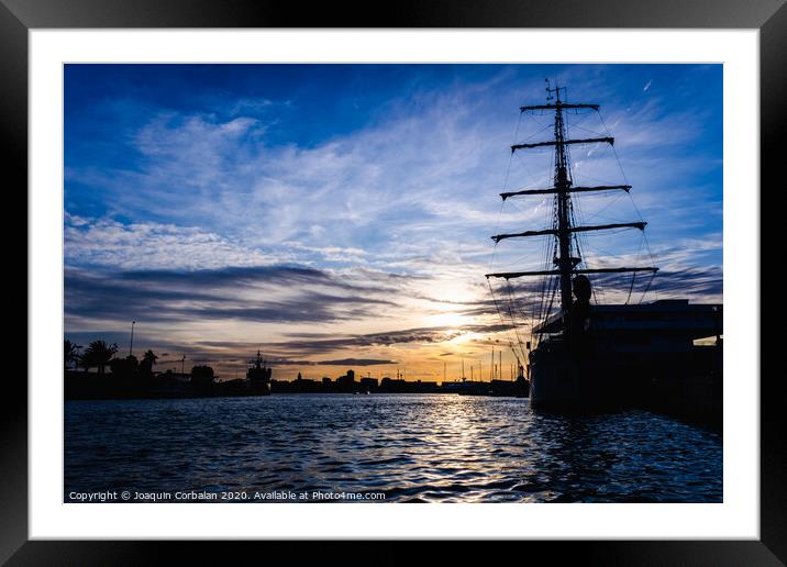 A classic sailboat moored to port in a beautiful sunset. Framed Mounted Print by Joaquin Corbalan