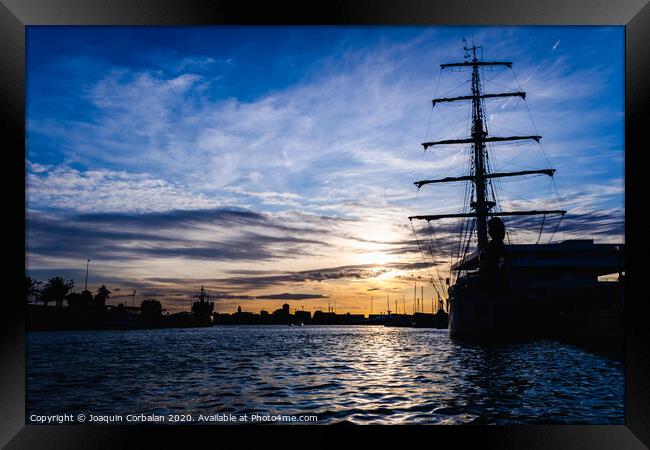 A classic sailboat moored to port in a beautiful sunset. Framed Print by Joaquin Corbalan