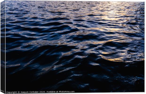 Waves on the surface of the sea water at dusk with compact, solid and deeply calm texture. Canvas Print by Joaquin Corbalan