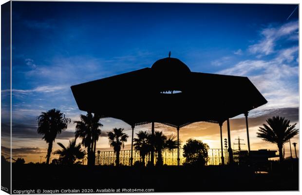 Silhouette of a pergola at sunset on a cloudy afternoon in the port of the Marina Real of Valencia, Spain. Canvas Print by Joaquin Corbalan