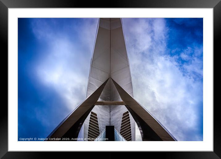 Modernist building with futuristic space design seen with the background of a dramatic blue sky. Framed Mounted Print by Joaquin Corbalan