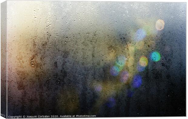 Beams of lights through a wet glass on a dark night, background of cold drops of water. Canvas Print by Joaquin Corbalan