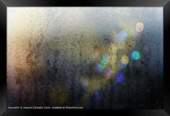 Beams of lights through a wet glass on a dark night, background of cold drops of water. Framed Print by Joaquin Corbalan