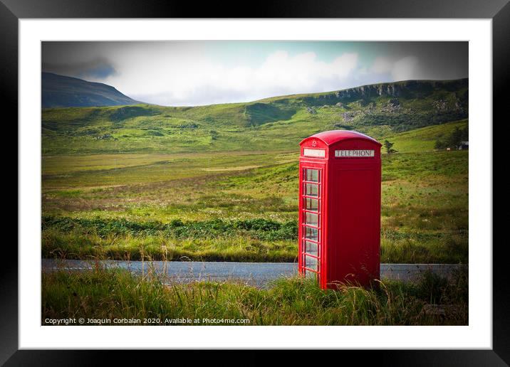 Typical red English telephone box in a rural area near a road. Framed Mounted Print by Joaquin Corbalan