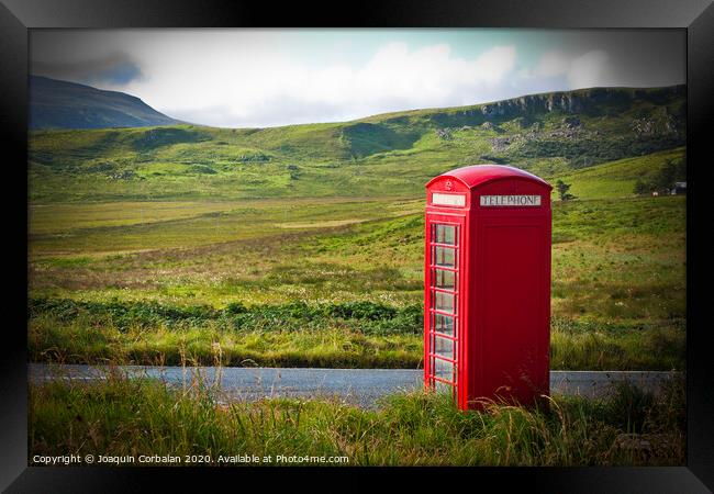 Typical red English telephone box in a rural area near a road. Framed Print by Joaquin Corbalan