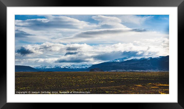 Beautiful and colorful blue skies with clouds and mountains in the background. Framed Mounted Print by Joaquin Corbalan
