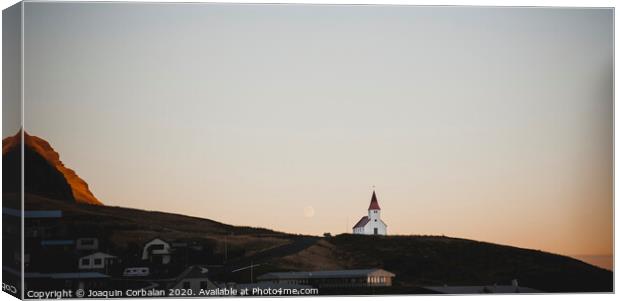 Church on top of a hill and under a mountain, with the moon in the background. Canvas Print by Joaquin Corbalan