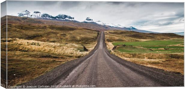 Gravel road in the snowy mountains of Iceland after a rainy day with mud Canvas Print by Joaquin Corbalan
