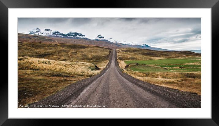 Gravel road in the snowy mountains of Iceland after a rainy day with mud Framed Mounted Print by Joaquin Corbalan
