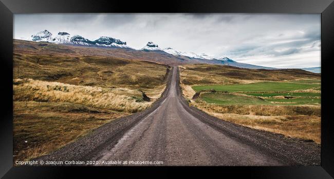 Gravel road in the snowy mountains of Iceland after a rainy day with mud Framed Print by Joaquin Corbalan