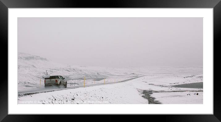 Cars circulating on snowy tracks during a winter storm. Framed Mounted Print by Joaquin Corbalan