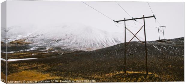 Poles of electricity in the middle of a snowy mountain to supply electrical power to remote villages. Canvas Print by Joaquin Corbalan