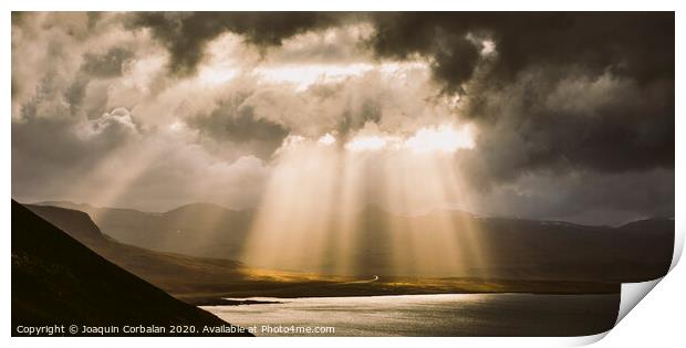 Sunbeams fall among the clouds in a lake between mountains. Print by Joaquin Corbalan