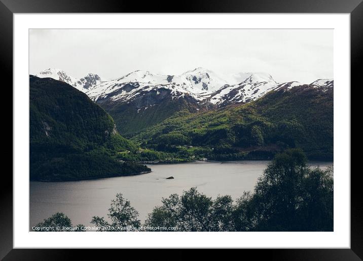 Lake surrounded by high snowy mountains in winter. Framed Mounted Print by Joaquin Corbalan