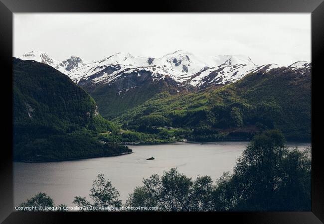 Lake surrounded by high snowy mountains in winter. Framed Print by Joaquin Corbalan
