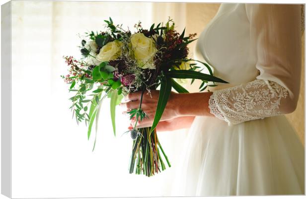 Bride holding her wedding bouquet Canvas Print by Joaquin Corbalan
