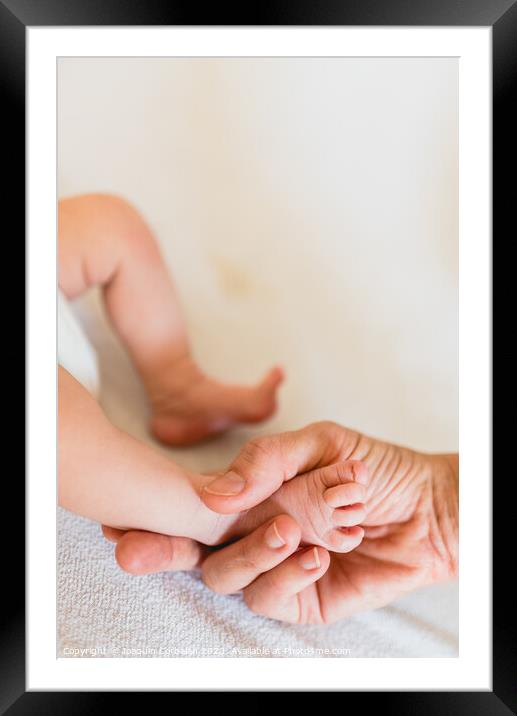 Mommy grabbing the little feet of her newborn daughter. Framed Mounted Print by Joaquin Corbalan
