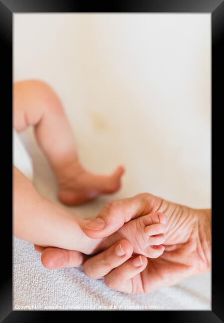Mommy grabbing the little feet of her newborn daughter. Framed Print by Joaquin Corbalan