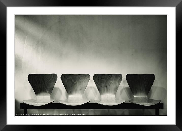 Waiting room with empty wooden chairs, concept of waiting and passage of time, black and white image, free space for text. Framed Mounted Print by Joaquin Corbalan