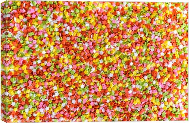 Close-up of colorful little stars made of sugar to decorate desserts, culinary background. Canvas Print by Joaquin Corbalan