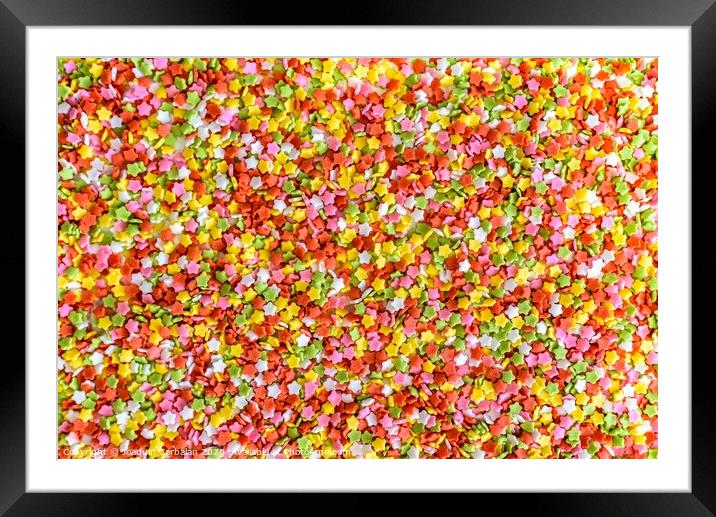 Close-up of colorful little stars made of sugar to decorate desserts, culinary background. Framed Mounted Print by Joaquin Corbalan