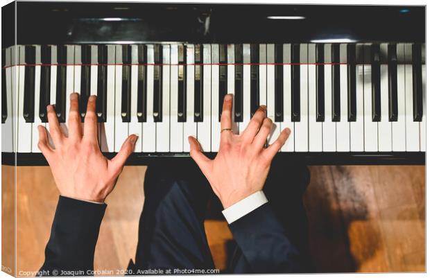 Pianist performing a piece on a grand piano with white and black keys., Seen from above... Canvas Print by Joaquin Corbalan