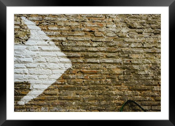 Brick wall with big white arrow indicating direction, background with copy space. Framed Mounted Print by Joaquin Corbalan
