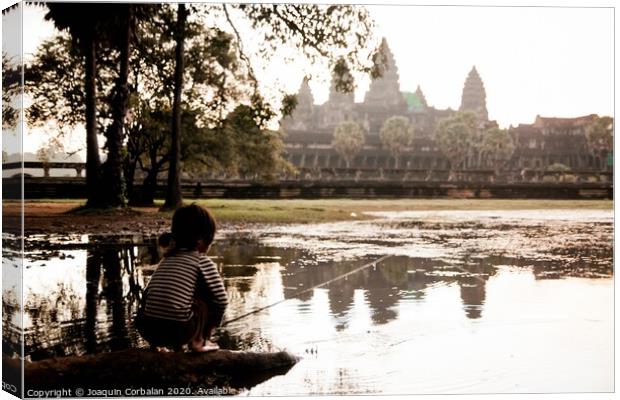 Girl fishing in the lake of Angkor Wat, ancient Cambodian city hidden in the forest very visited by tourists Canvas Print by Joaquin Corbalan