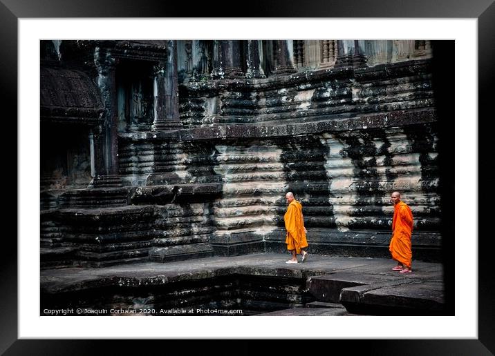 tibetan monks in orange robes visiting remote Cambodian temples to meditate. Framed Mounted Print by Joaquin Corbalan