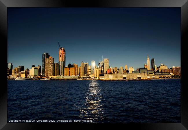 view of Riverside Park next to the city skyline at sunset from the Hudson River. Framed Print by Joaquin Corbalan