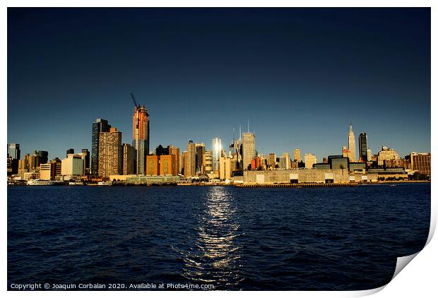 view of Riverside Park next to the city skyline at sunset from the Hudson River. Print by Joaquin Corbalan