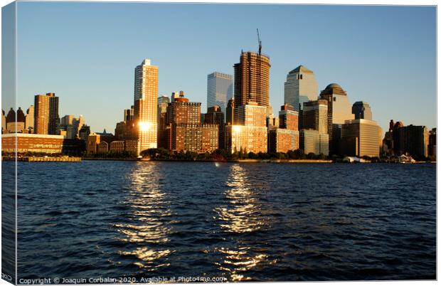  View of Riverside Park next to the city skyline at sunset from the Hudson River. Canvas Print by Joaquin Corbalan