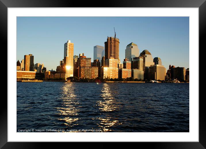  View of Riverside Park next to the city skyline at sunset from the Hudson River. Framed Mounted Print by Joaquin Corbalan