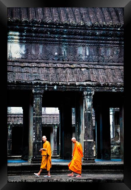 Buddhist monks meditating while walking through the Angkor Thom temple Framed Print by Joaquin Corbalan
