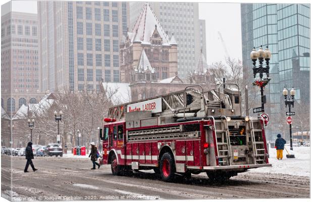 Fire truck traveling the snowy streets of the city. Canvas Print by Joaquin Corbalan