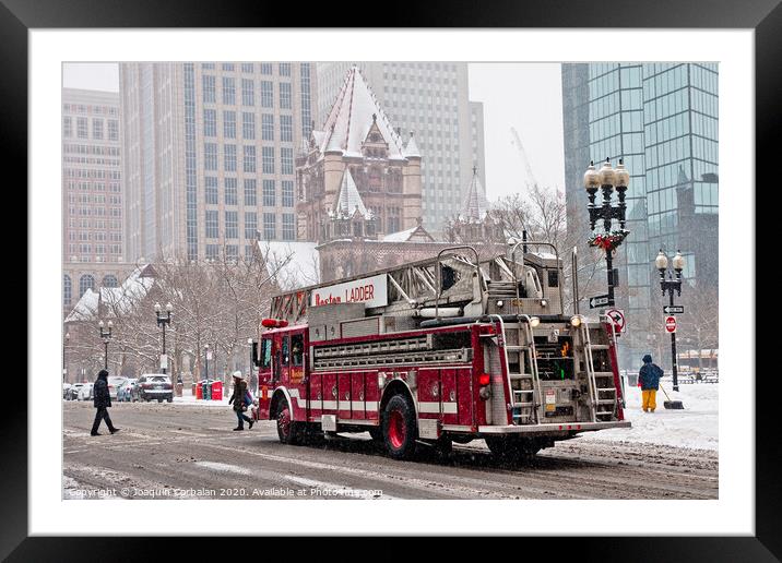 Fire truck traveling the snowy streets of the city. Framed Mounted Print by Joaquin Corbalan