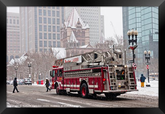 Fire truck traveling the snowy streets of the city. Framed Print by Joaquin Corbalan
