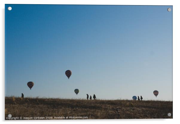 Goreme, Turkey - April 4, 2012: Hot air balloons for tourists flying over rock formations at sunrise in the valley of Cappadocia. Acrylic by Joaquin Corbalan