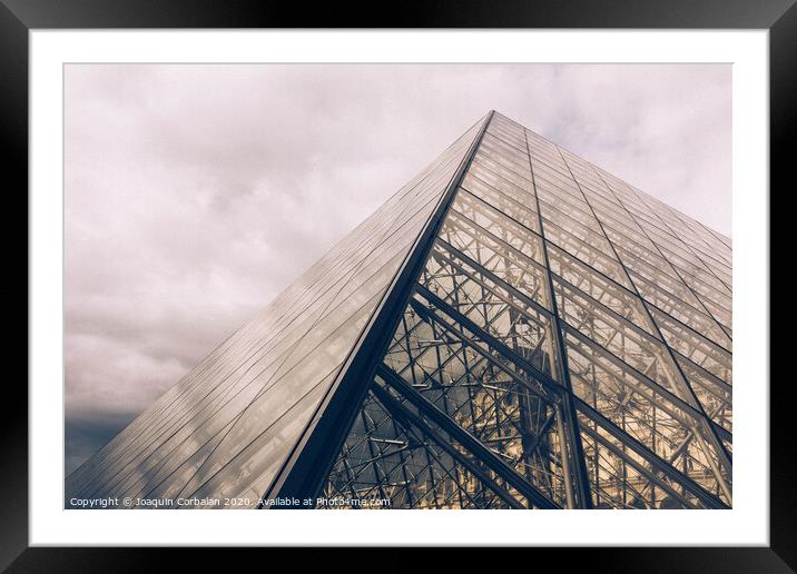 Crystal pyramid in Paris, sample of modern architecture on a cloudy day Framed Mounted Print by Joaquin Corbalan